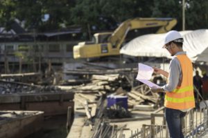 construction-engineer-working-bridge-construction-site-rivercivil-engineer-supervising-workforeman-inspects-work-construction-site